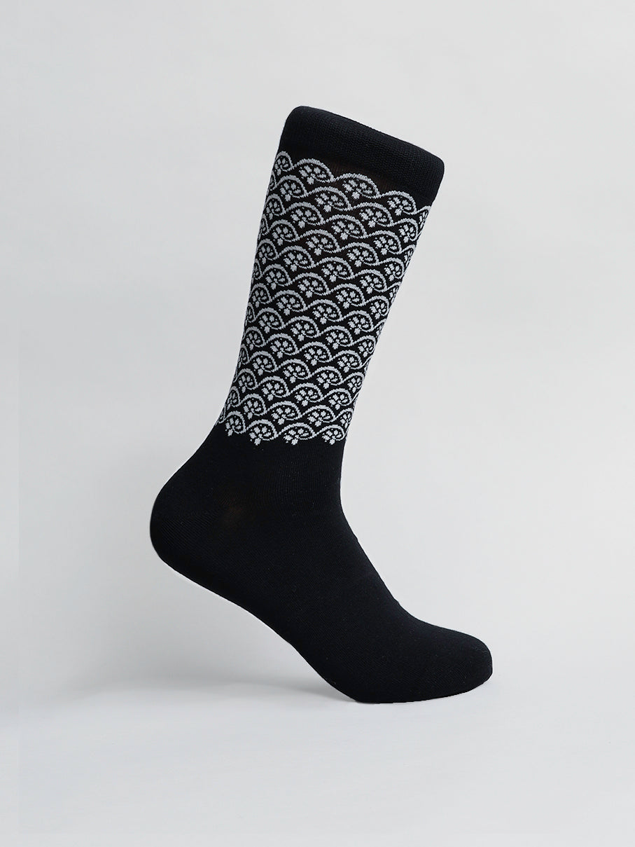 The black Lotus Graphic Socks by ID Menswear feature a white geometric semicircle pattern from ankle to top. Made with combed cotton, these breathable socks are displayed on a plain white background, offering both style and comfort.