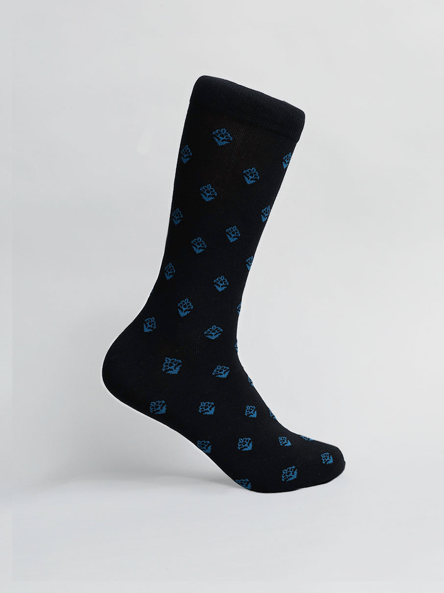 The Mysore Graphic Socks by ID Menswear are black with a breathable blue geometric pattern, made from combed cotton and showcased on a plain white background.