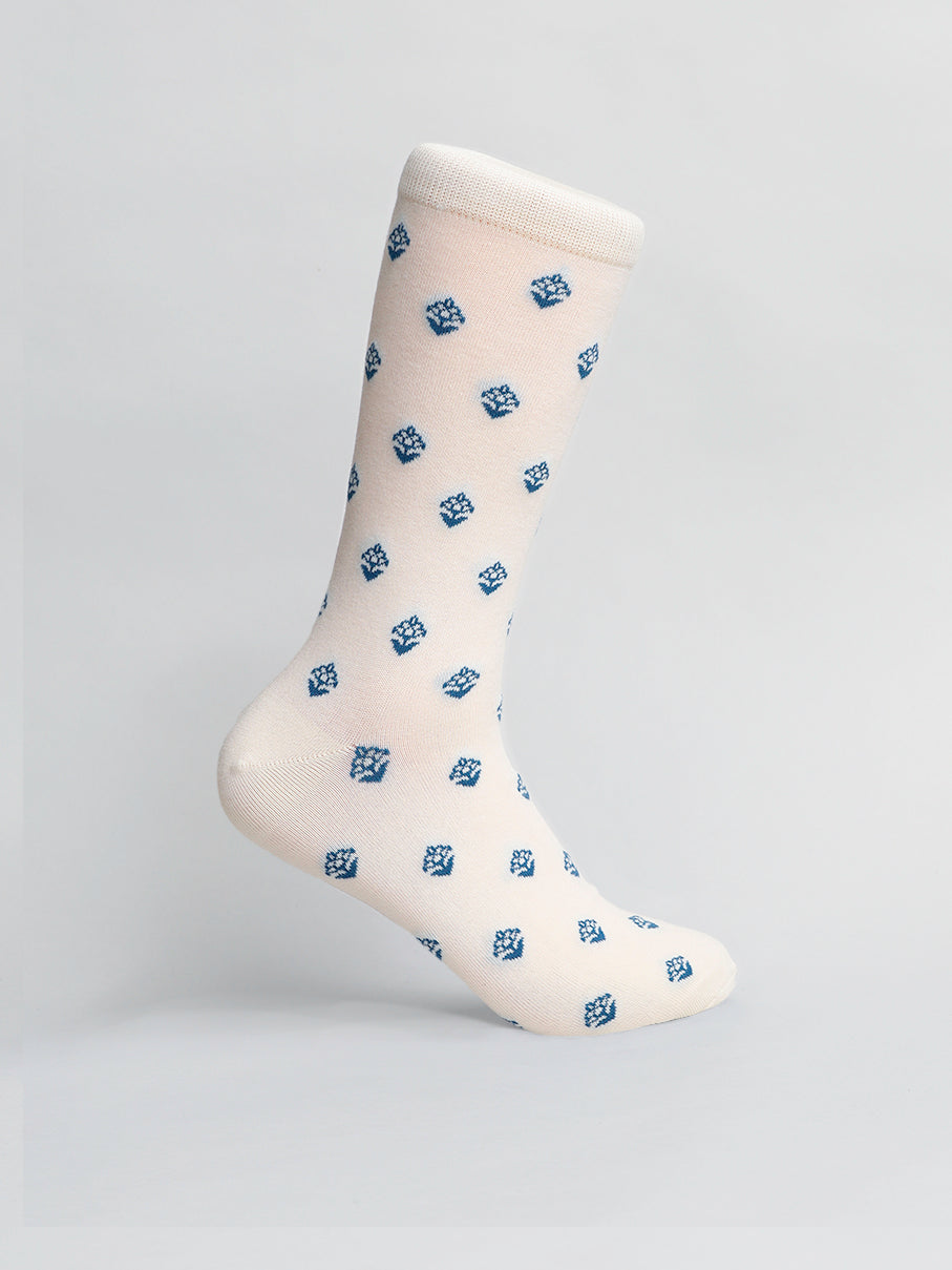 The Mysore Graphic Socks by ID Menswear feature an off-white design with blue dice patterns, crafted from breathable combed cotton, and shown upright against a light gray background.