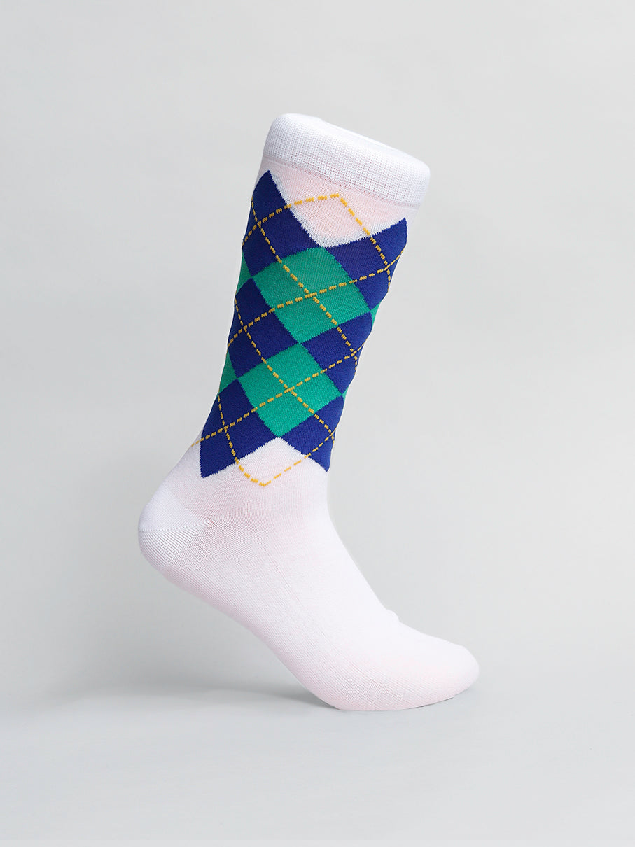 A single Argyle Graphic Sock from ID Menswear features a classic argyle design in blue, green, and black with yellow stitching. Made from soft combed cotton, it stands upright against a plain light gray background.