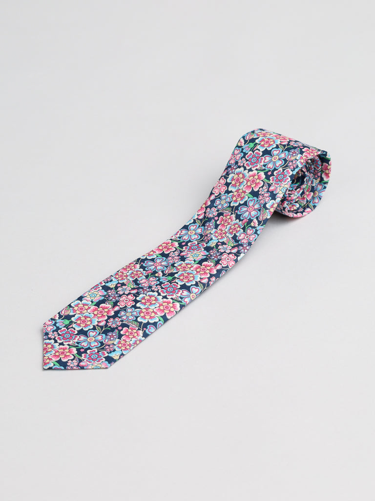 The Liberty of London Tana Lawn™ Anokhi Tie by ID Menswear is a handmade navy blue necktie with colorful floral patterns, crafted in Brooklyn from premium fabric and shown on a plain white background.