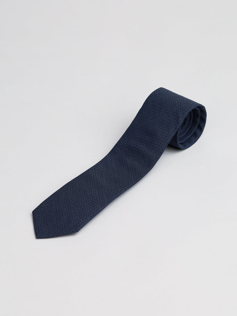 The Starry Night Cotton Tie by ID Menswear, in navy blue cotton, is neatly rolled and displayed on a plain light gray background.