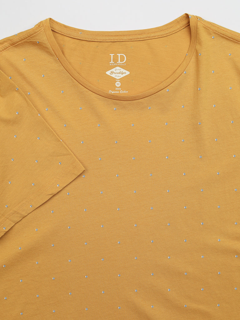 The Heritage Printed Organic Cotton Tee by ID Menswear is a mustard yellow, classic-fit T-shirt adorned with small white polka dots. It is displayed laid flat, highlighting the front and part of the left sleeve.