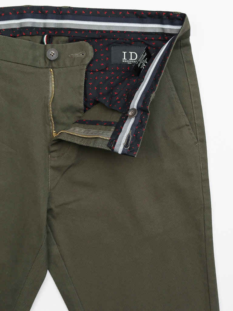 Olive green Wythe Twill Stretch Chino pants by ID Menswear, featuring a partially open zipper and button that reveals a black waistband with red heart pattern. Ideal for casual occasions, these well-tailored cotton twill pants have a smooth feel and an inside label.