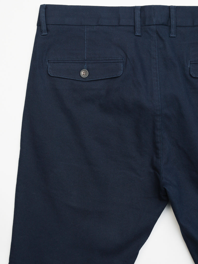 The Wythe Twill Stretch Chino by ID Menswear in dark navy blue offers a slim fit with a button-closure back pocket, cotton twill fabric, belt loops, and a tailored appearance ideal for casual occasions.