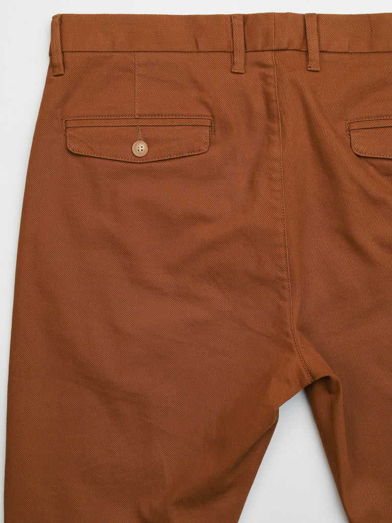 The Wythe Twill Stretch Chino by ID Menswear features a close-up of the back with two buttoned pockets, crafted from sturdy and slightly textured cotton twill, ideal for casual wear.