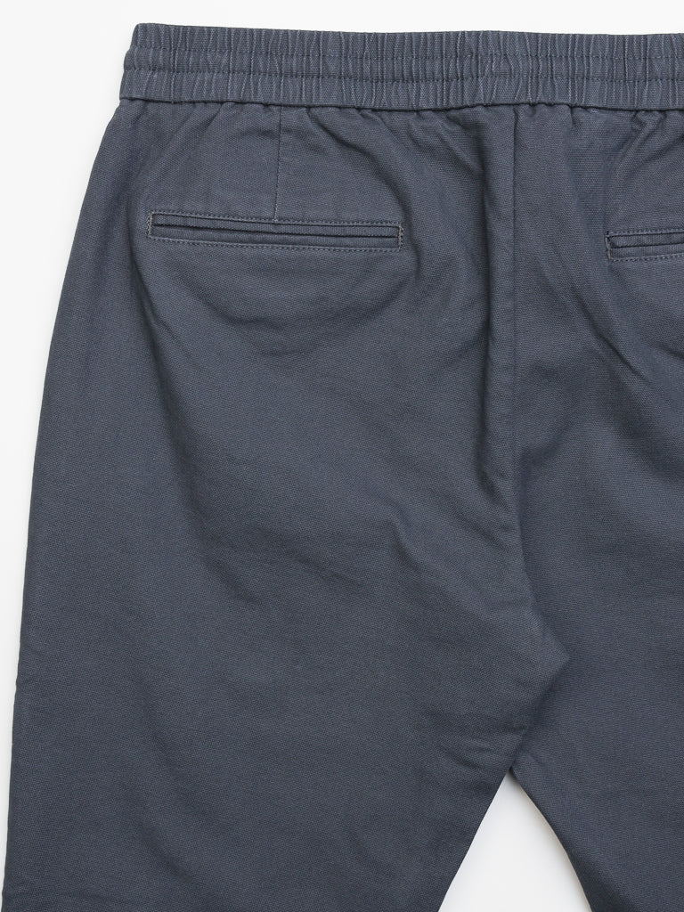 The Kent Drawstring Canvas Pants by ID Menswear are dark gray, slim-fit, mid-rise trousers featuring an elastic waistband and two rear pockets. Laid flat against a white background, the fabric looks smooth and comfortable with a cotton canvas texture.