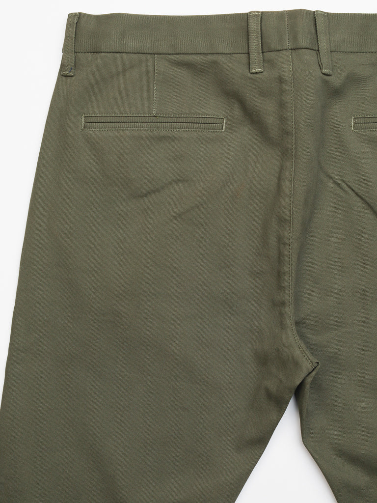 Back view of olive green ID Menswear Banker Twill Stretch Chino with belt loops and two stitched horizontal rear pockets. These mid-rise, regular slim-fit pants feature a smooth, slightly textured fabric for a polished look.