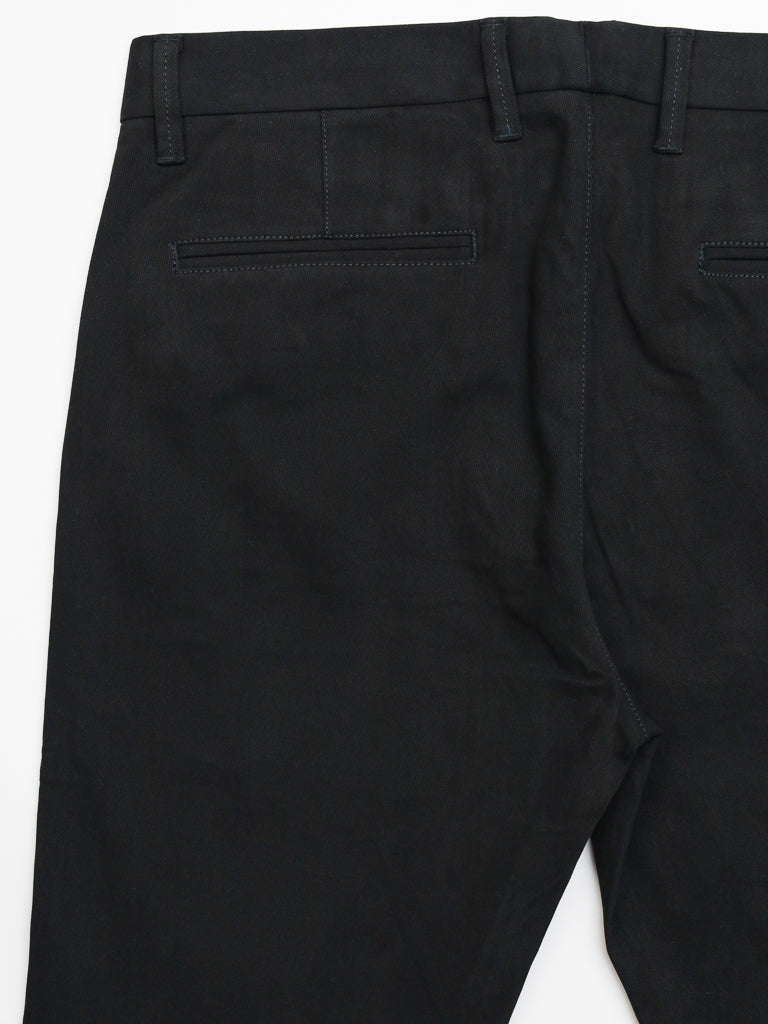 A close-up of ID Menswears Banker Twill Stretch Chino in black highlights the two welt pockets and belt loops, featuring a sleek regular slim-fit silhouette, set against a plain white background.