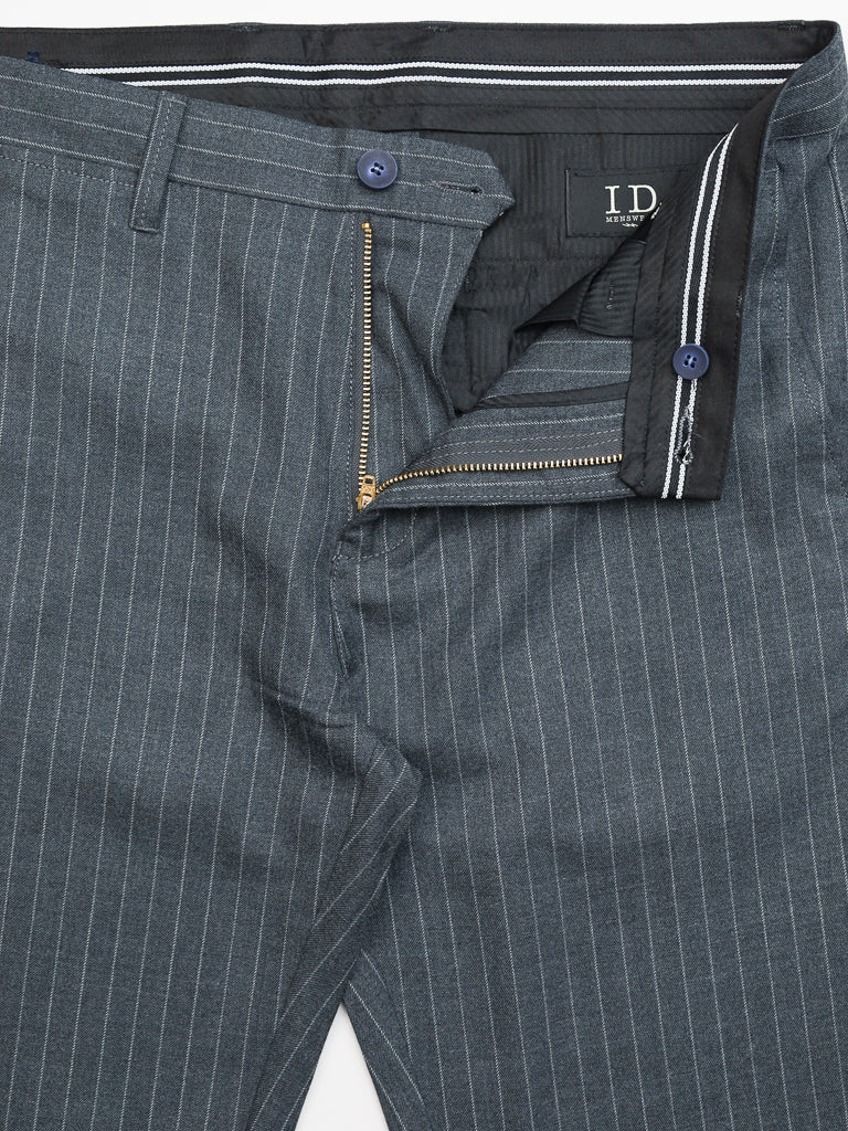 The Hudson Wool Blend Pin Stripe Pant by ID Menswear is designed in premium wool with a gray pinstripe, featuring a mid-rise slim fit, a partially open zipper and button fly, and a black interior waistband lining with white stripes and a black label with white lettering.