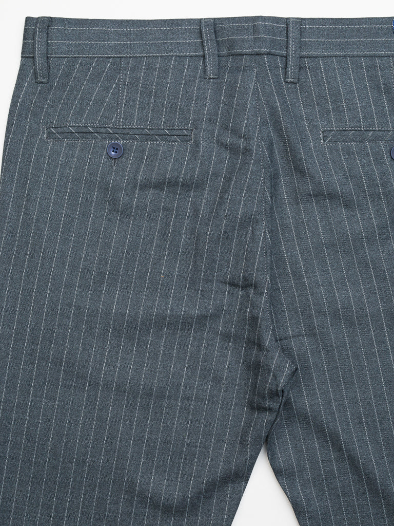 The Hudson Wool Blend Pin Stripe Pant from ID Menswear features a mid-rise slim-fit cut with gray pinstripes and vertical white stripes for a classic look, complete with belt loops and two back pockets adorned with blue buttons.