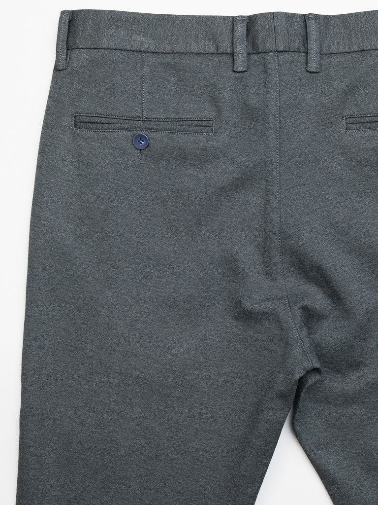 The Manhattan 4-way Stretch Dress Pant by ID Menswear is perfect for business casual attire, featuring a blue button on one back pocket and belt loops. These slim-fit, wrinkle-resistant pants are showcased against a crisp white background.