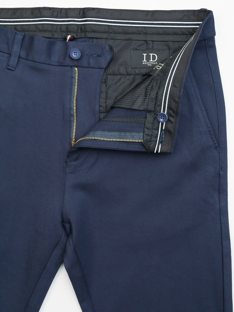 Navy blue Manhattan 4-way Stretch Dress Pants by ID Menswear feature a partially open zipper and button, subtly revealing the inner lining. The I D label inside the waistband makes these slim-fit pants ideal for a sophisticated business casual look.