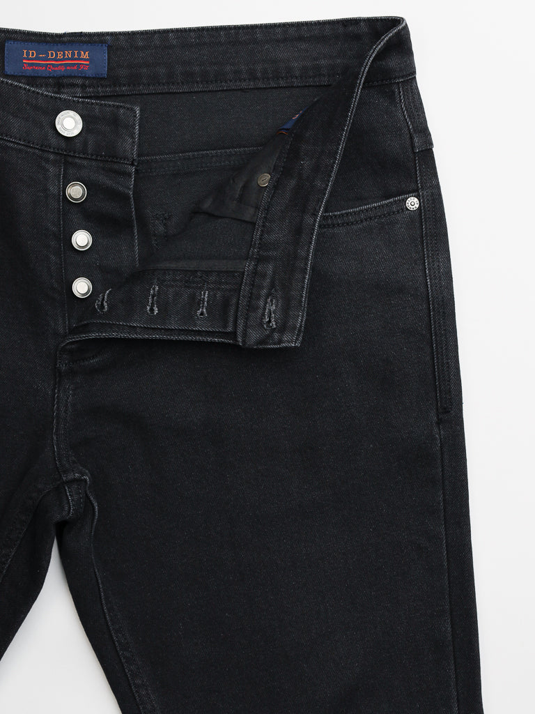 The Ganbaru Stretch Jean by ID Menswear, crafted from sleek black denim, features an open button fly with visible buttons and front pockets. It offers a slim-tapered fit for a modern silhouette, and the waistband displays a small fabric label. Displayed flat on white for clarity.