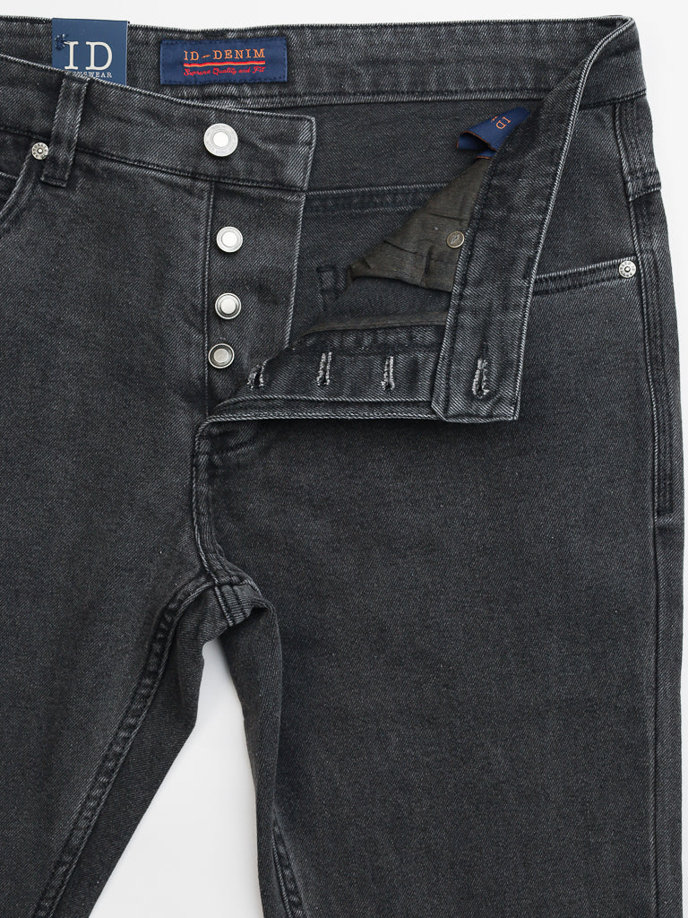 The Ganbaru Stretch Jean by ID Menswear is a pair of slim-tapered black denim jeans, crafted from cotton twill, featuring a front button fly with partially visible silver buttons, a waistband with belt loops, and an inside brand label.